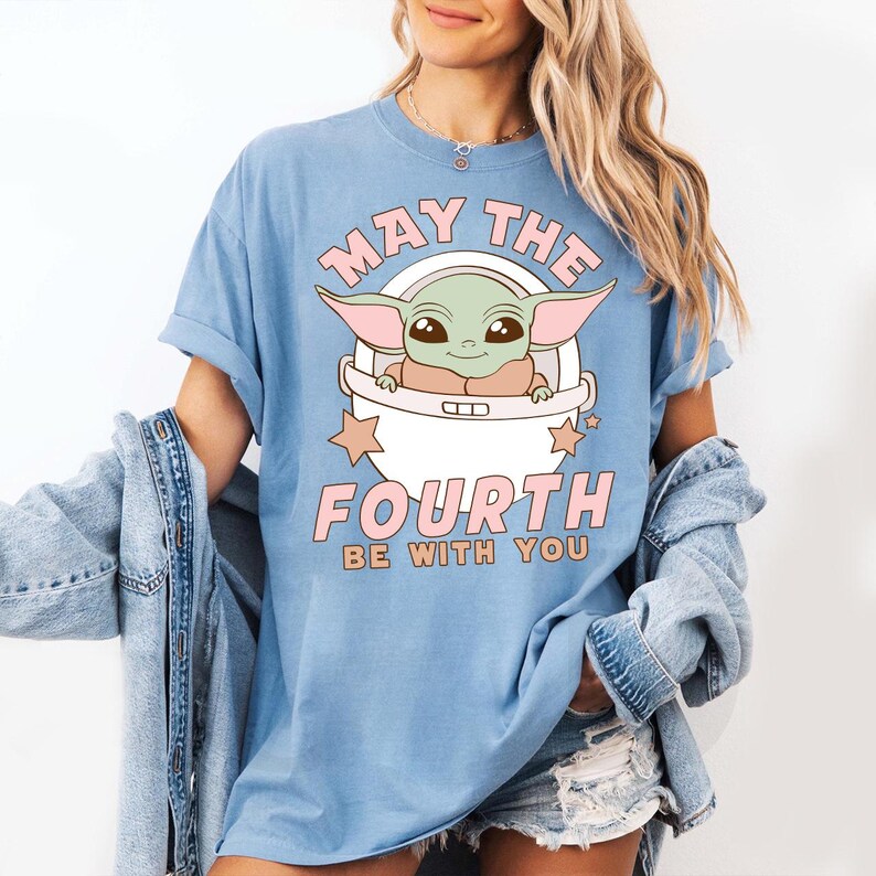 a woman wearing a blue star wars t - shirt