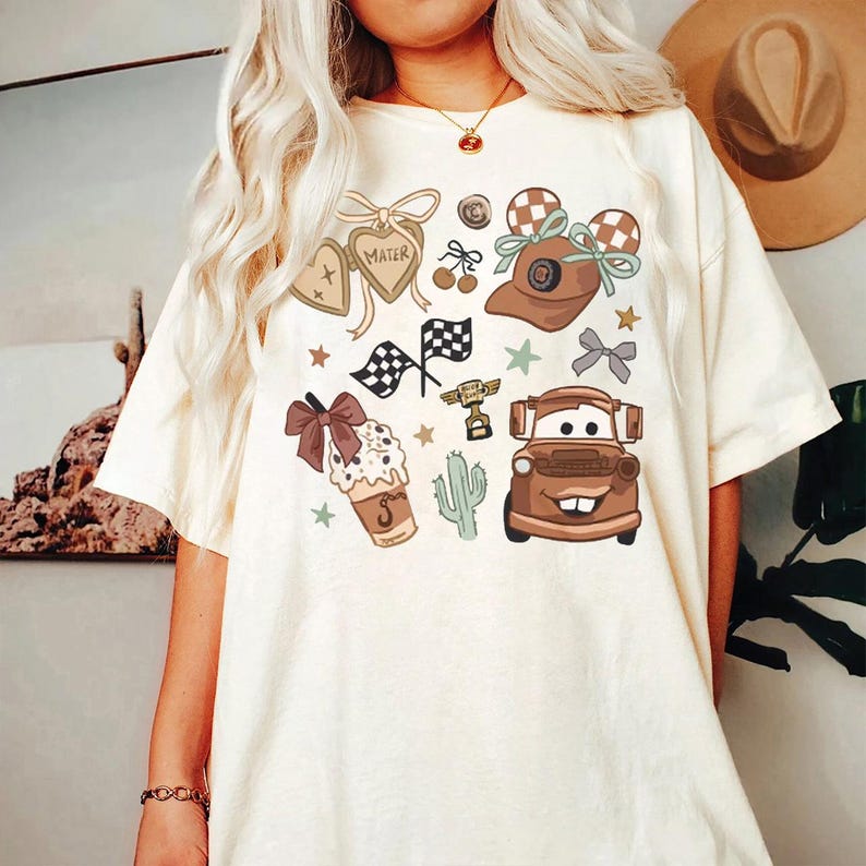 a woman wearing a white tshirt with cars on it