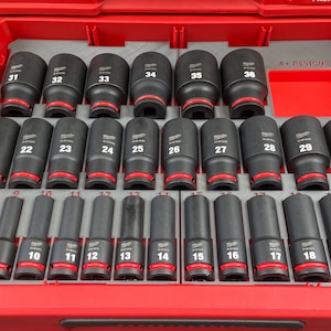 May include: A red toolbox with a grey foam insert containing a set of black socket wrenches. The wrenches are labelled with numbers from 8 to 38.