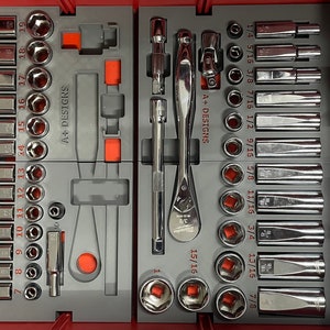 May include: A red toolbox with a grey foam insert containing a set of chrome socket wrenches and a chrome ratchet wrench. The wrenches are labelled with their sizes in fractions of an inch. The box is labelled "A+ Designs".