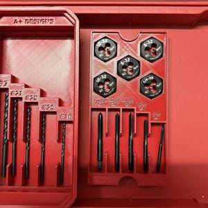 May include: A red tool case with compartments holding various tools. The case contains drill bits and tap and die sets. The drill bits are labelled with sizes. The tap and die sets are labelled with sizes such as 10-32 and 1/4-20.