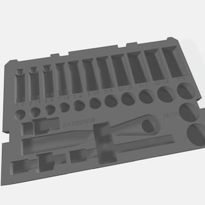May include: A grey plastic tool organiser with various sized compartments and slots for holding tools. The organiser has the text "LL Designs" printed on it.