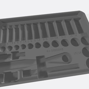 May include: A grey plastic tool organiser with various sized compartments for holding tools. The organiser has a long, narrow compartment for a wrench and a round compartment for a screwdriver.