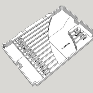 May include: A black and white line drawing of a seating plan for a theater or auditorium. The plan shows rows of seats with measurements in inches, labeled with numbers. The plan also includes a section labeled "A+ Designs".