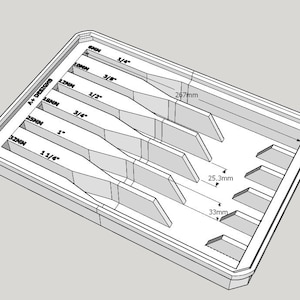 May include: A white plastic storage tray with seven slots for organizing tools. The slots are labeled with fractions of an inch and millimeters. The tray measures 26.7 inches by 3.3 inches.