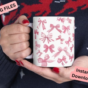 May include: White ceramic mug with a pink and white gingham bow pattern. The mug is being held by a hand. The text "Instant Download" is visible in the lower right corner of the image.