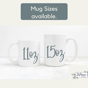 May include: Two white ceramic mugs, one labeled "11oz" and the other "15oz" in a script font. The text "Mug Sizes available" is at the top. The mugs are on a white surface.