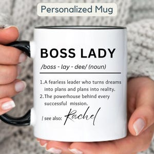 May include: White ceramic mug with a black handle and rim, featuring the text "BOSS LADY" in bold black letters. The mug includes a definition and the name "Rachel" in script. The words "Personalized Mug" are at the top.