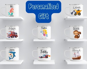 May include: White enamel mugs with various cartoon illustrations and names. Designs include a mermaid, fire truck, unicorn, monkey, shark, race car, and sailboat. The text "Personalized Gift" is displayed in a blue bubble.