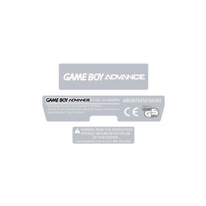 May include: A white background with three grey rectangular labels. The top label reads "GAME BOY ADVANCE." The middle label includes text about the model, rating, and a serial number. The bottom label warns to read the instruction booklet.