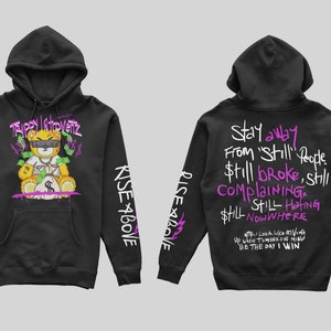 May include: Black hoodie with a cartoon bear holding money on the front and the text "Trippy Introvert" above the bear. The sleeves have the text "Rise Above" and "#blessed" printed on them. The back of the hoodie has the text "Stay away from 'Still' people $till broke, still ComplainING $till HATING $till NOW WHERE I look like on Ving UP WHEN TOMORROW MIEG BE THE DAY I WIN" printed in pink.