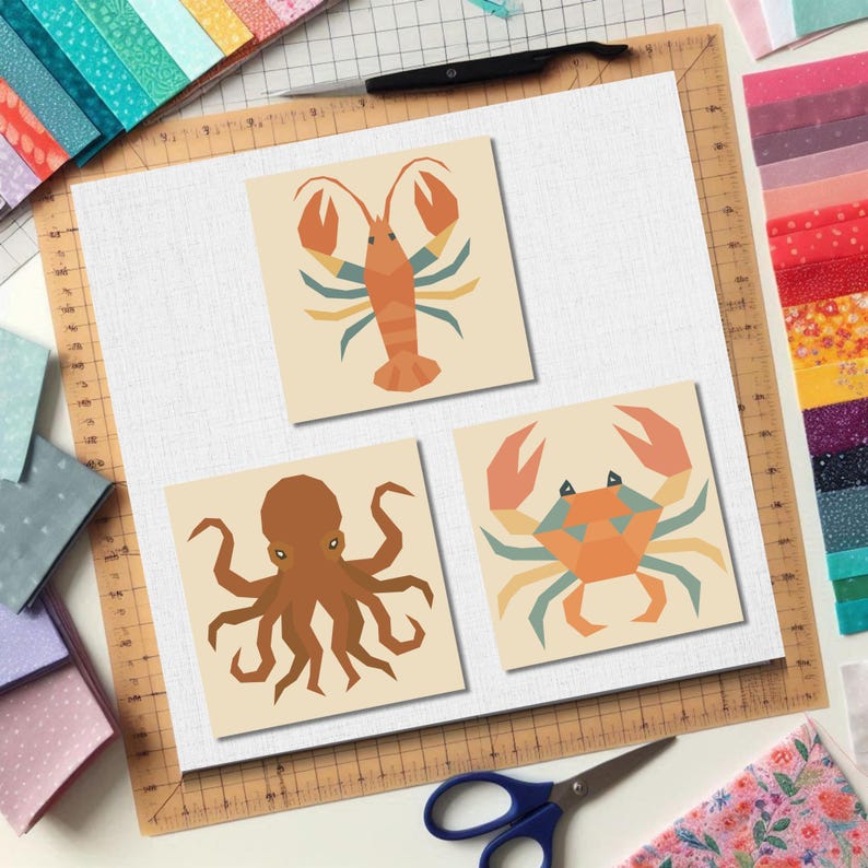 May include: Three square art prints featuring sea creatures: a lobster, an octopus, and a crab. The lobster is orange with blue and yellow accents. The octopus is brown. The crab is orange and blue. The prints are on a cream background.