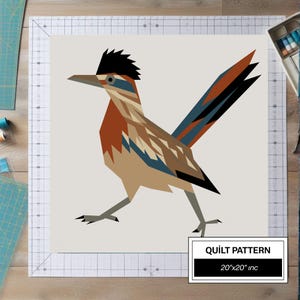 May include: A geometric quilt pattern featuring a stylized roadrunner bird in shades of brown, blue, black, and tan against a light background. The design includes a text box labeled QUILT PATTERN with the dimensions 20"x20" inc clearly printed.