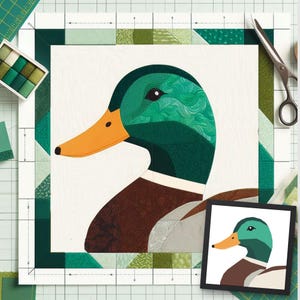 May include: A mallard duck quilt block pattern featuring a green head, orange beak, and brown chest, constructed from various green and brown patterned fabric pieces. The square block is framed by a green border and includes a small reference image.