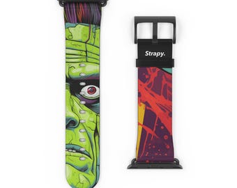May include: Two black watch bands. One band features a green and purple Frankenstein monster design. The other band has a colorful abstract design with the word "Strapy." printed on the black buckle.