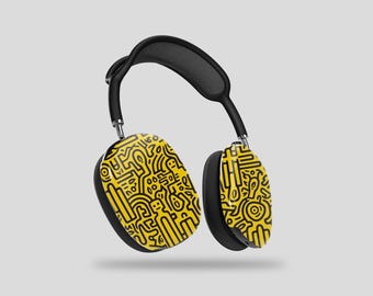 May include: Black wireless headphones with yellow earcups featuring a black and yellow abstract pattern.