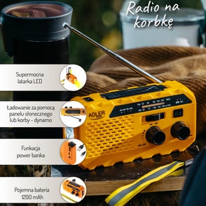 May include: A yellow and black hand crank radio with a built-in flashlight, solar panel, and power bank. The radio has a digital display and AM/FM tuning knobs. The text "Radio na korbkę" is visible on the image.