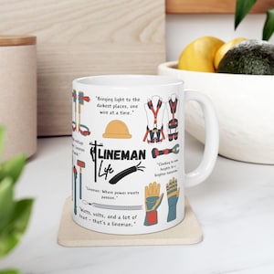 May include: White ceramic mug featuring a colourful illustration of a lineman, tools, and quotes about the job. The text on the mug reads "Lineman Life", "Bringing light to the darkest places, one wire at a time.", "Linemen: Where power meets passion.", "Climbing to new heights for a brighter tomorrow.", and "Watts, volts, and a lot of heart - that's a lineman."
