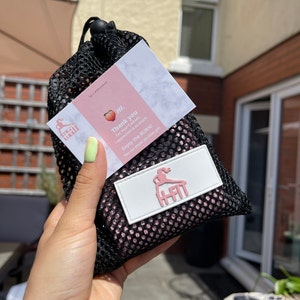 May include: A pink and black mesh bag with a white card that says "HI. Thank you for your custom, I appreciate it so much. Enjoy the BURN! You can thank me later girl." and a white tag with the word "HFIT" in pink letters.