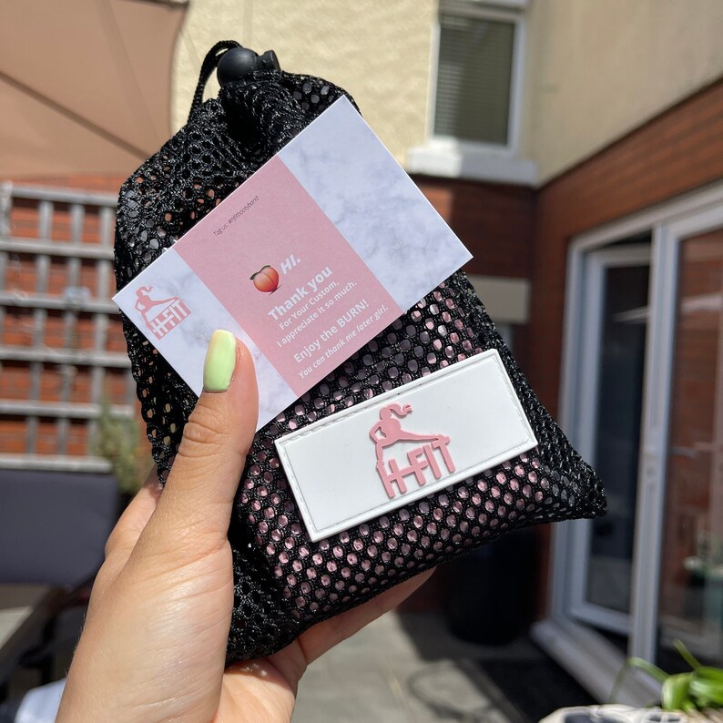 May include: A pink and black mesh bag with a white card that says "HI. Thank you for your custom, I appreciate it so much. Enjoy the BURN! You can thank me later girl." and a white tag with the word "HFIT" in pink letters.