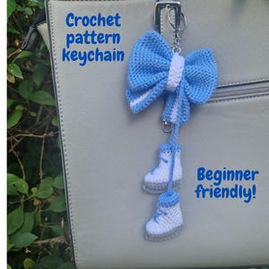 May include: A handmade crochet keychain featuring a blue bow with white accents and two miniature white and blue sneakers. The text "Crochet pattern keychain" and "Beginner friendly!" are visible.