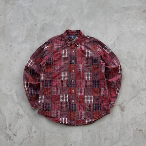 May include: A button-down shirt with a patchwork design in shades of red, burgundy, and white. The shirt features a classic collar and long sleeves. The fabric appears to be a woven material, with a mix of plaid and solid patterns.