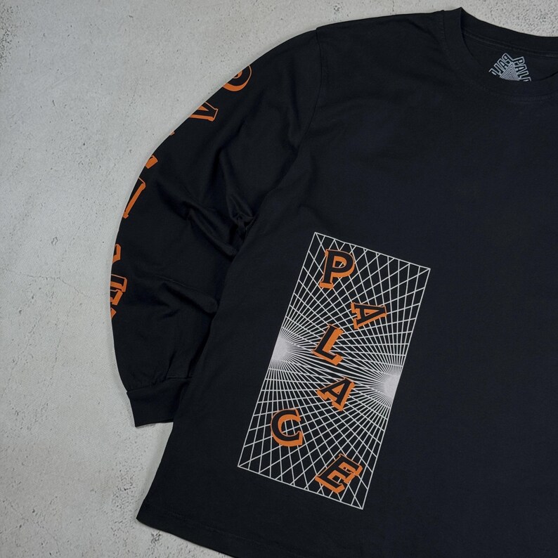 May include: Black long-sleeve t-shirt with an orange "PALACE" graphic on a white grid background.