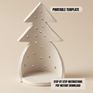 May include: A white ceramic Christmas tree-shaped decoration with a hollow interior and small circular cutouts. The text "PRINTABLE TEMPLATE" and "STEP BY STEP INSTRUCTIONS PDF INSTANT DOWNLOAD" are visible.
