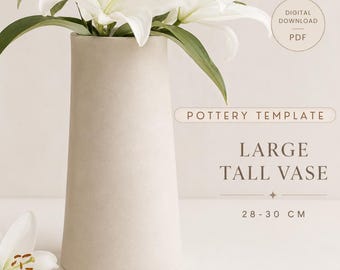 May include: A tall, cylindrical beige vase with a smooth matte finish, holding white lily flowers. Text on the image reads: DIGITAL DOWNLOAD PDF, POTTERY TEMPLATE, LARGE TALL VASE, 28-30 CM. The vase is designed for a height of 28 to 30 centimeters.