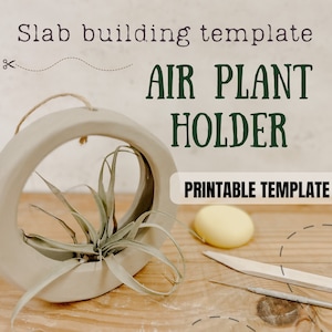 May include: A printable template for a DIY air plant holder. The template is for a round, light gray ceramic holder with a hole in the center. The holder is shown with a small air plant inside. The text "AIR PLANT HOLDER" is written in large, green letters above the holder. The text "PRINTABLE TEMPLATE" is written in smaller, black letters below the holder.