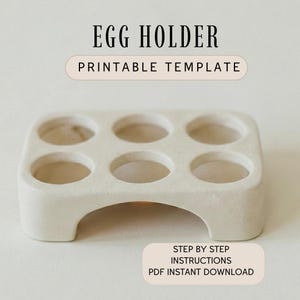 May include: A beige egg holder with six circular openings. The words "EGG HOLDER PRINTABLE TEMPLATE" are at the top. The bottom of the image reads "STEP BY STEP INSTRUCTIONS PDF INSTANT DOWNLOAD".