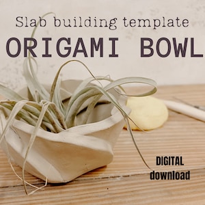 May include: A white ceramic bowl with a folded origami design, holding a green air plant. The bowl is on a wooden surface with the text "Slab building template ORIGAMI BOWL DIGITAL download" above it.