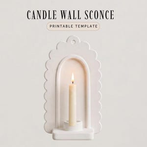 a white candle wall sconce with a lit candle inside, creating a warm and cozy atmosphere.