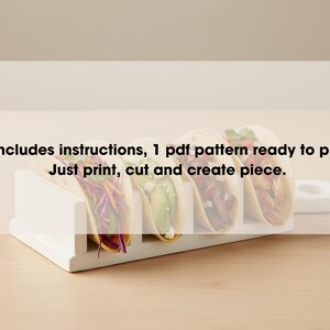 May include: A white taco holder containing four tacos with diverse fillings. The image includes text: "It includes instructions, 1 pdf pattern ready to print. Just print, cut and create piece."