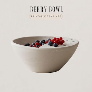May include: A beige ceramic berry bowl filled with fresh blueberries and red currants. The bowl has a unique design with a built-in colander section. Text on the image reads "BERRY BOWL PRINTABLE TEMPLATE."