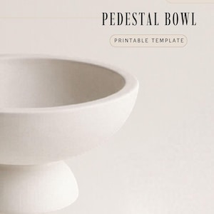 May include: A white pedestal bowl with a rounded top and a sturdy base. The text "PEDESTAL BOWL" is at the top, with "PRINTABLE TEMPLATE" below it. The bowl is likely made of ceramic or a similar material.