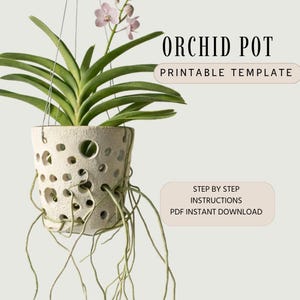 May include: A hanging orchid pot with a cream-colored, textured finish and numerous circular openings. The pot holds a vibrant green orchid plant with long leaves and delicate pink flowers. Text on the image reads "ORCHID POT PRINTABLE TEMPLATE".