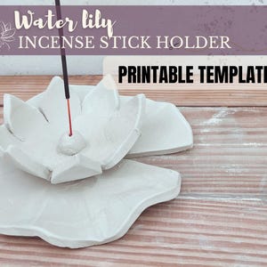 May include: Printable template for a water lily incense stick holder. The template is a white, ceramic design of a water lily with a hole in the centre for an incense stick.