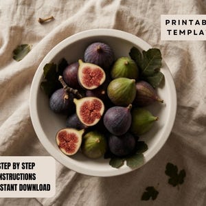 A bowl filled with sliced figs and leaves, placed on a beige cloth.