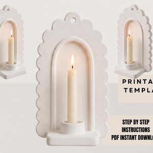 a white candle holder with a lit candle inside, set against a plain white background.