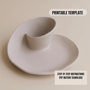 a white ceramic dish with a curved shape, placed on a light-colored surface.
