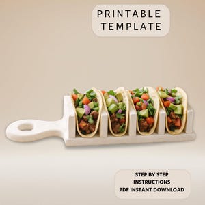 May include: A white taco holder with five tacos filled with meat, avocado, tomatoes, and onions. The tacos are arranged in a row. The image includes the text "PRINTABLE TEMPLATE" and "STEP BY STEP INSTRUCTIONS PDF INSTANT DOWNLOAD".