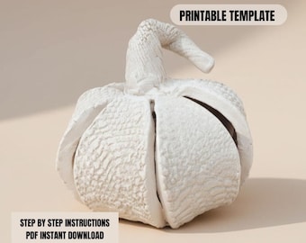 May include: A white, textured pumpkin-shaped decorative object with a curved stem. The pumpkin is split into sections. Text on the image reads "PRINTABLE TEMPLATE" and "STEP BY STEP INSTRUCTIONS PDF INSTANT DOWNLOAD".