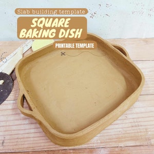 May include: A printable template for a square baking dish, made of clay. The template is on a wooden surface with a ruler, a scraper, and a sponge.