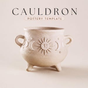 May include: A light beige ceramic cauldron featuring two side handles and three small feet. The exterior is embossed with a central sun face surrounded by moon phases and small circular dots. The text CAULDRON POTTERY TEMPLATE appears above.