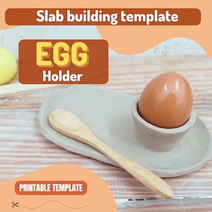 May include: A printable template for a ceramic egg holder. The template shows a gray egg holder with a brown egg inside, a wooden spoon, and a gray oval-shaped base. The text "EGG Holder" is printed in red on a brown rectangle.