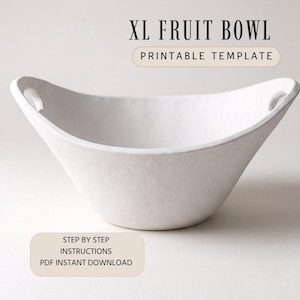 May include: A white, XL fruit bowl with a wide, curved design and small handles. The text "XL FRUIT BOWL PRINTABLE TEMPLATE" is at the top. Below, the text reads "STEP BY STEP INSTRUCTIONS PDF INSTANT DOWNLOAD".