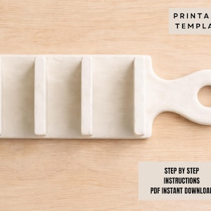 May include: Cream-coloured soap dish with a handle and three raised bars. The dish is rectangular with a rounded handle featuring a circular opening. The text "PRINTABLE TEMPLATE" and "STEP BY STEP INSTRUCTIONS PDF INSTANT DOWNLOAD" are visible.