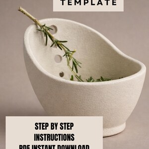 a white ceramic bowl with a sprig of green herbs inside, placed on a light-colored surface.