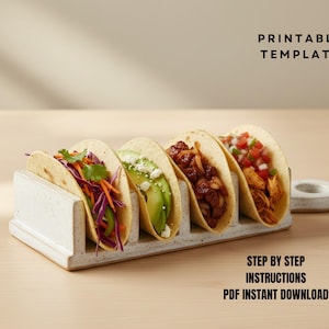 May include: A white ceramic taco holder containing five filled tacos. The tacos are filled with ingredients like shredded cabbage, avocado, and meat. The text "PRINTABLE TEMPLATE" and "STEP BY STEP INSTRUCTIONS PDF INSTANT DOWNLOAD" are visible.